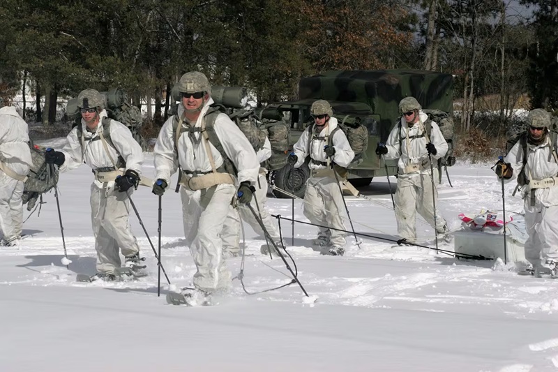 Soldiers hiking over snow on skis