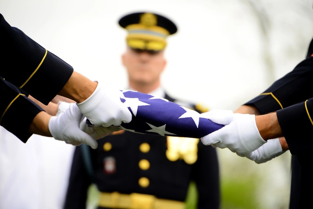 Army soldiers folding American flag at funeral