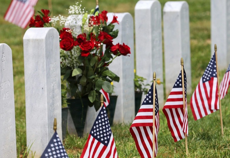 American flags next to graves in military cemetery