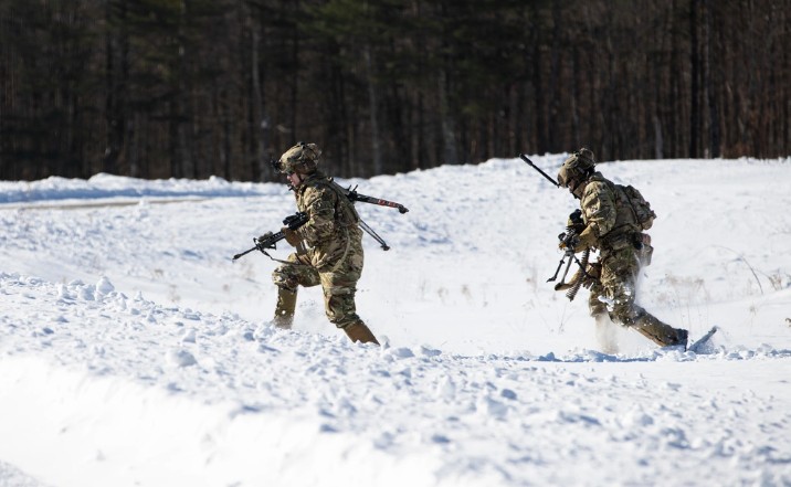 Military professionals walking in snow wearing ECWCS