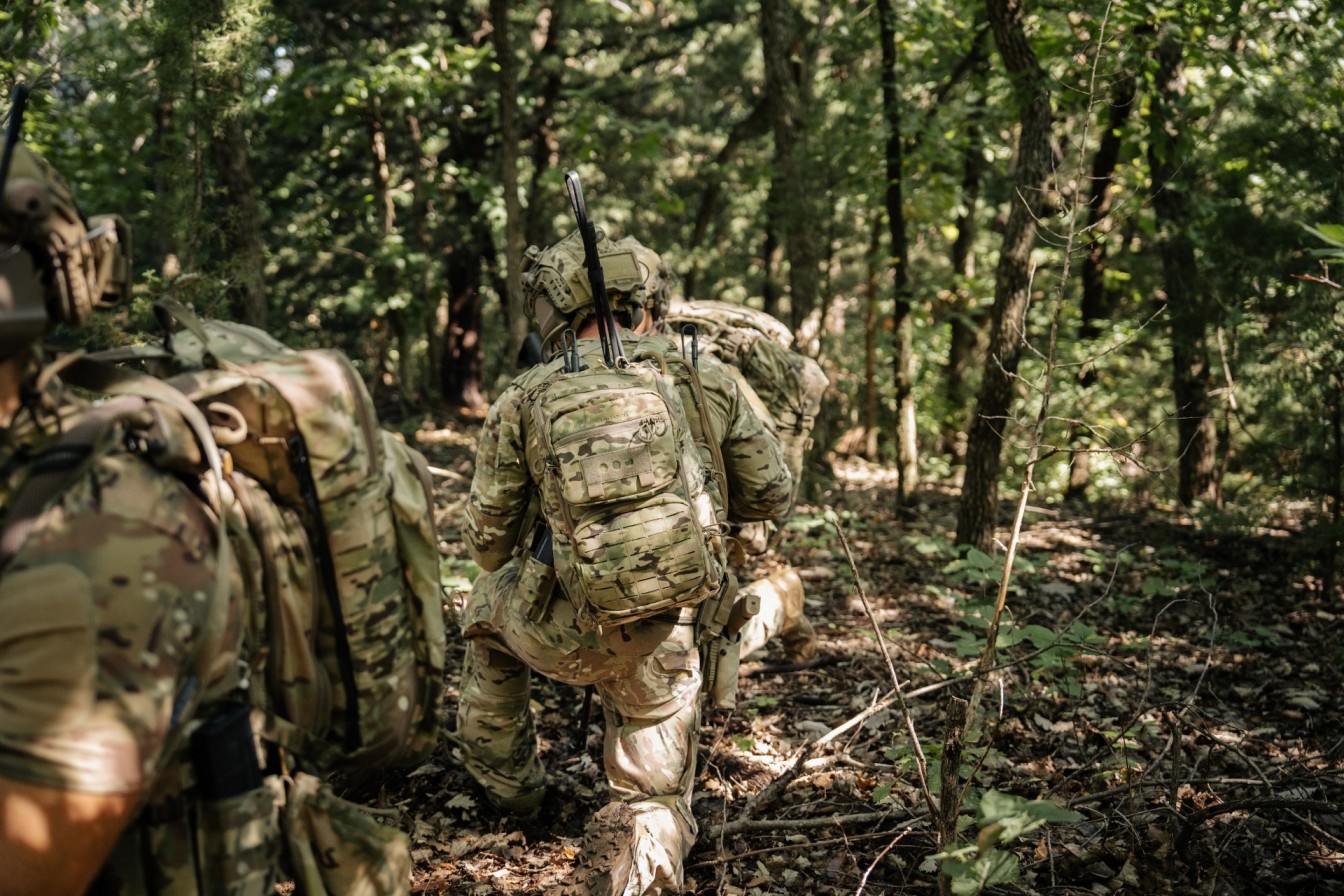 Soldiers kneeling down in forest